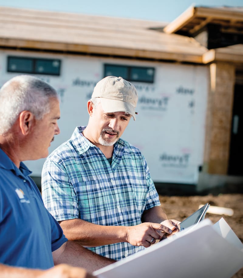 Two Builders looking over some plans