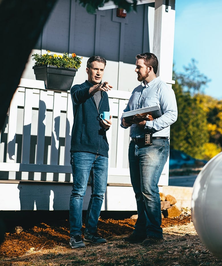 Service technician talking to customer outside