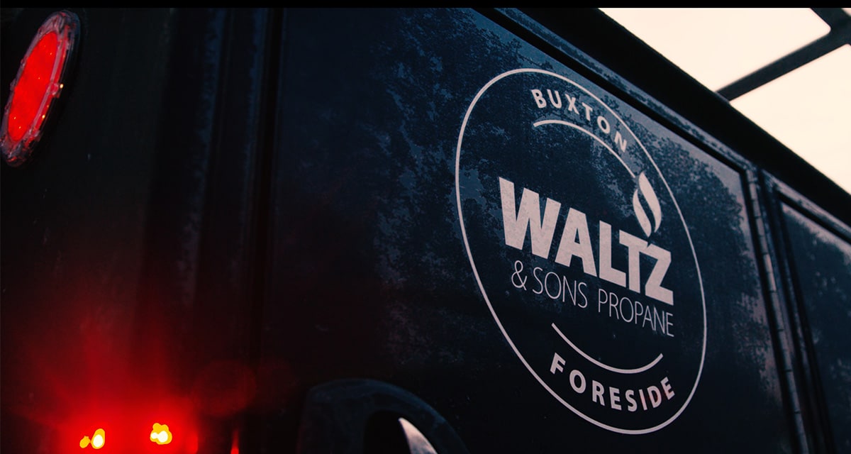 side of blue waltz pickup with company logo